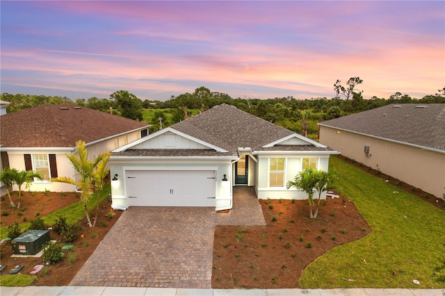 view of front facade with a lawn and a garage