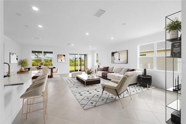 tiled living room featuring crown molding