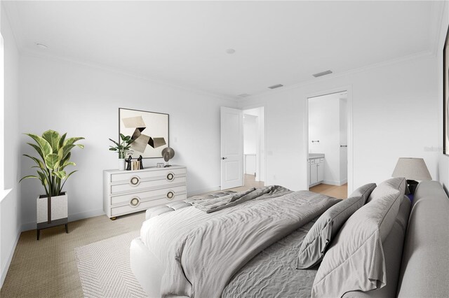 carpeted bedroom with ensuite bath and crown molding