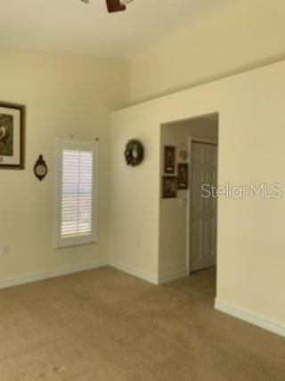 carpeted empty room with ceiling fan