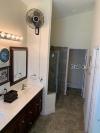 bathroom with vanity and a shower with door