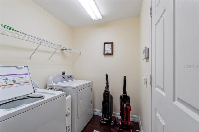 washroom featuring separate washer and dryer and dark hardwood / wood-style floors