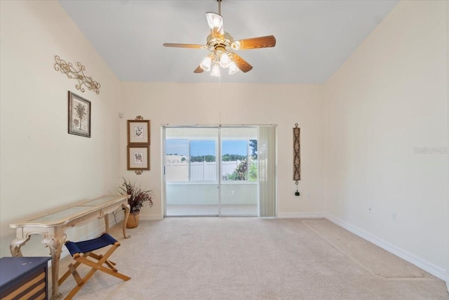 interior space with ceiling fan and light colored carpet