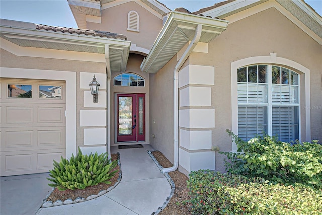 view of exterior entry featuring a garage