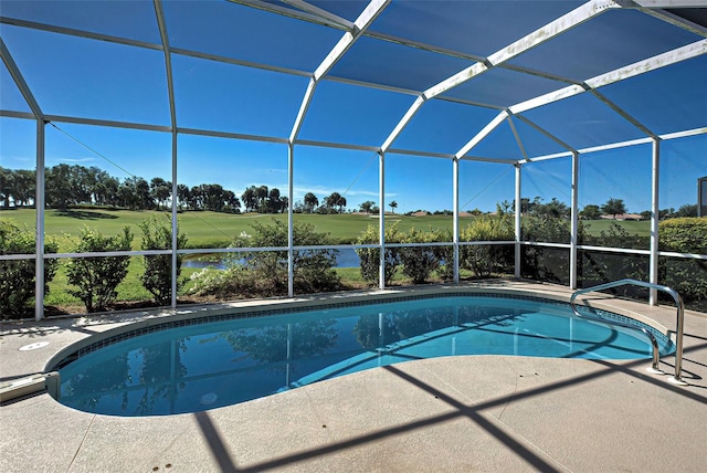 view of swimming pool featuring a patio and a lanai