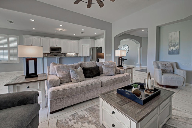 living room with ceiling fan and light tile floors