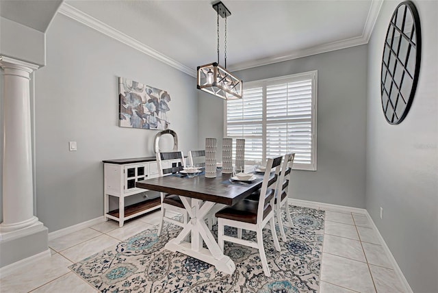 tiled dining space featuring crown molding and decorative columns