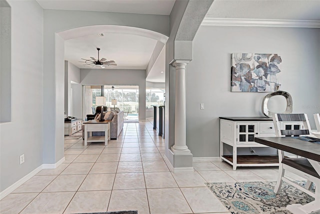 tiled entrance foyer with crown molding, ceiling fan, and decorative columns