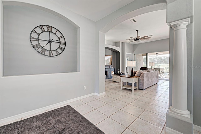 interior space featuring ceiling fan and decorative columns