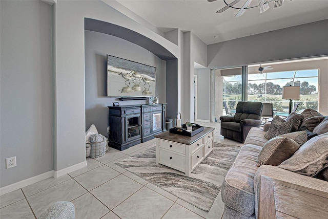 tiled living room featuring ceiling fan