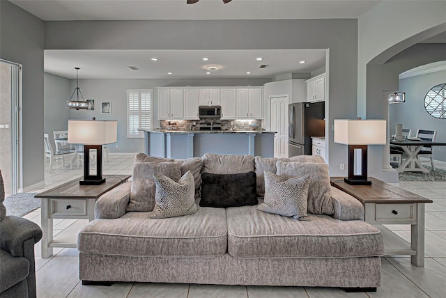 living room with ceiling fan and light tile floors