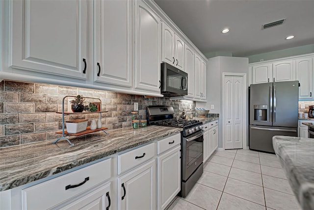 kitchen with backsplash, stainless steel appliances, and white cabinets