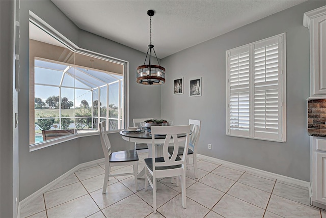 tiled dining room with a textured ceiling