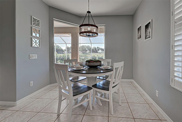 tiled dining area featuring a notable chandelier