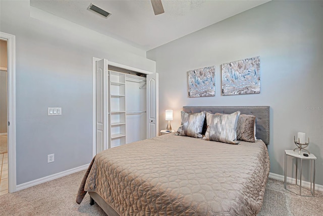 carpeted bedroom featuring a closet and ceiling fan