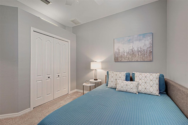 bedroom with light colored carpet, a closet, and ceiling fan