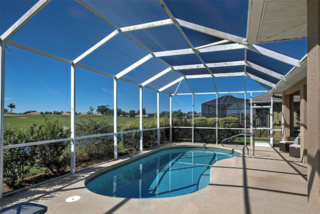 view of swimming pool with a patio area and glass enclosure