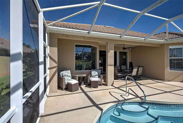 sunroom / solarium featuring ceiling fan