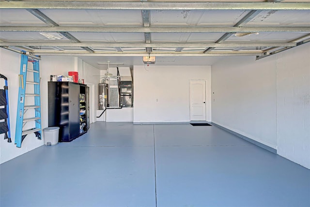 garage featuring water heater, heating utilities, and a garage door opener