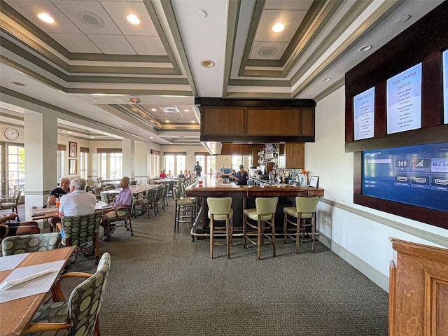 interior space with a raised ceiling and crown molding