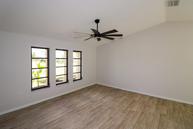 spare room with light hardwood / wood-style flooring, ceiling fan, and lofted ceiling