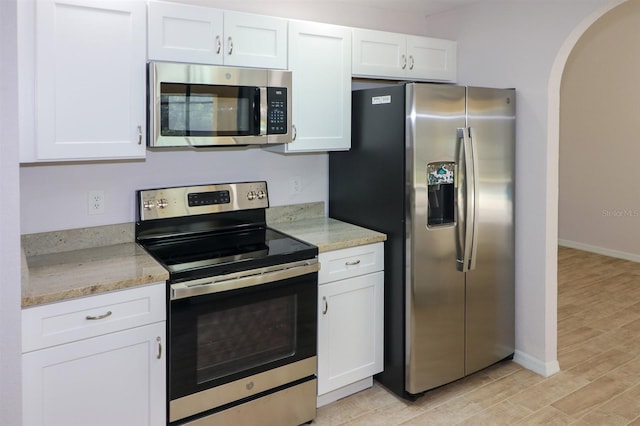 kitchen featuring light hardwood / wood-style flooring, stainless steel appliances, and white cabinets