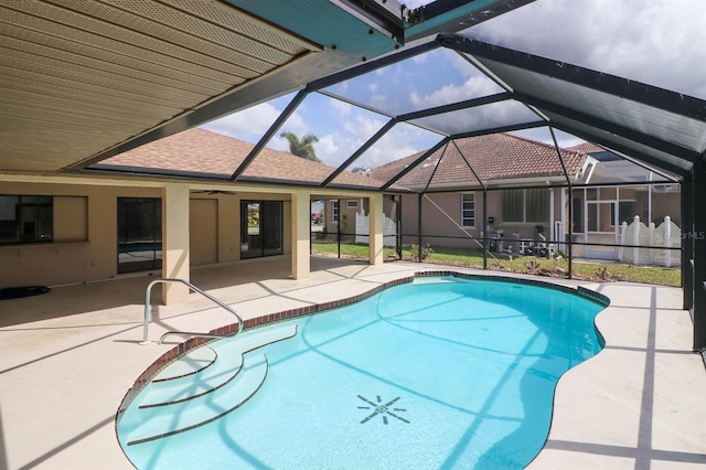 view of swimming pool with a patio area and a lanai