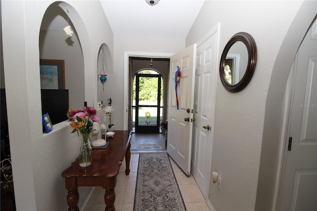 tiled entrance foyer featuring lofted ceiling