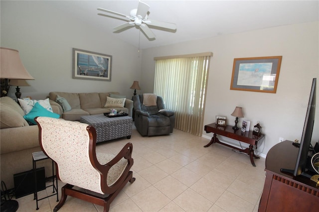 living room featuring ceiling fan, light tile floors, and lofted ceiling