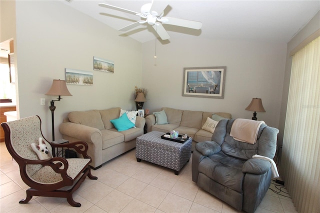 living room with lofted ceiling, ceiling fan, and light tile floors