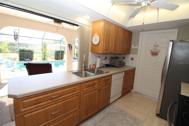 kitchen with ceiling fan, sink, light tile flooring, stainless steel fridge, and white dishwasher