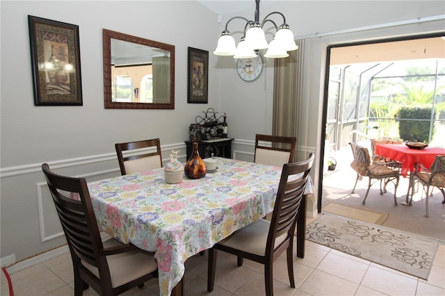 tiled dining room featuring a notable chandelier