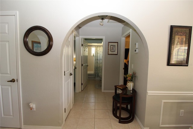 hall featuring light tile floors