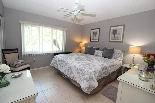 bedroom featuring ceiling fan and light tile floors