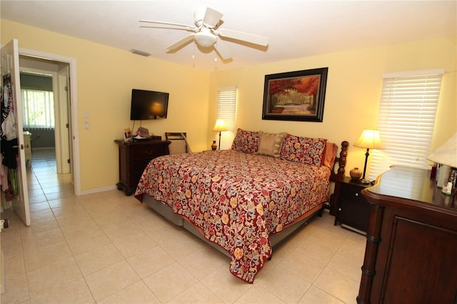 bedroom with ceiling fan and light tile flooring