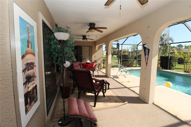 view of terrace with a lanai and ceiling fan