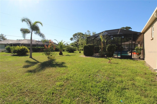 view of yard featuring glass enclosure and a pool