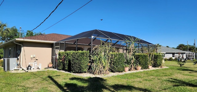 view of yard featuring central AC unit and a lanai