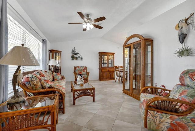 tiled living room with plenty of natural light, ceiling fan, and lofted ceiling