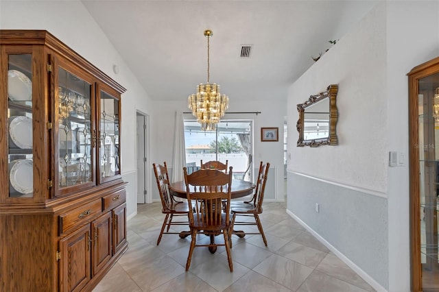 tiled dining space featuring lofted ceiling and a notable chandelier