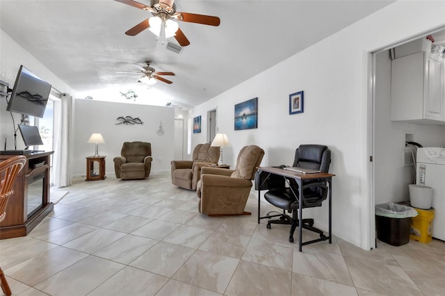 tiled living room featuring washer / dryer, ceiling fan, and vaulted ceiling