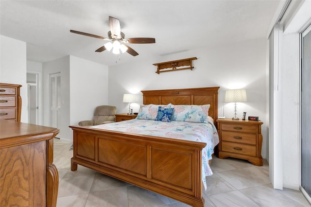 bedroom with a closet, ceiling fan, and light tile floors