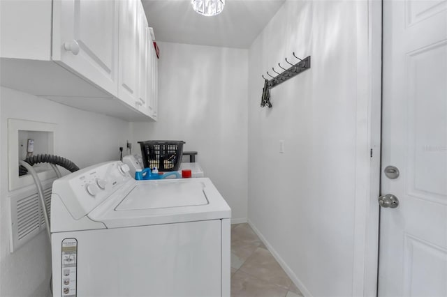 laundry area with independent washer and dryer, cabinets, and light tile floors