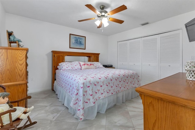 bedroom with a closet, ceiling fan, and light tile flooring