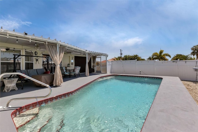 view of pool with an outdoor living space, ceiling fan, and a patio