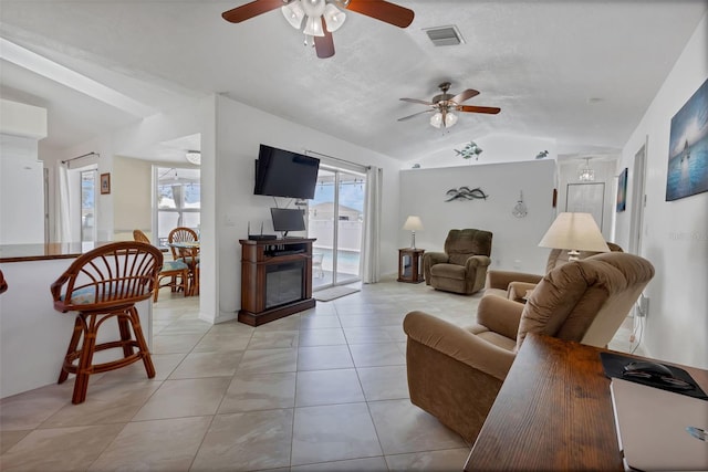 tiled living room featuring lofted ceiling and ceiling fan