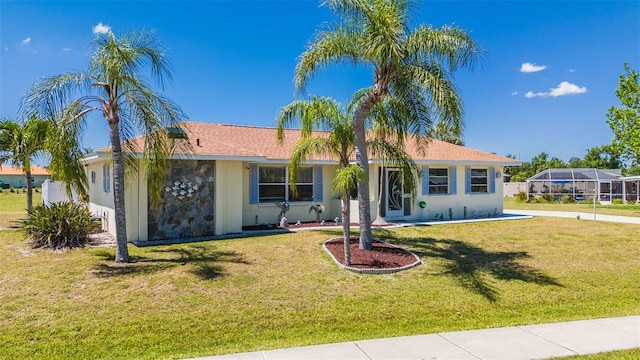 view of front facade with a lanai and a front lawn