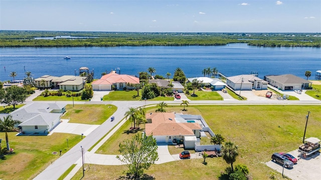 birds eye view of property with a water view