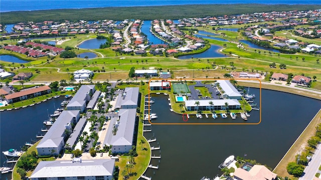 birds eye view of property with a water view and a residential view