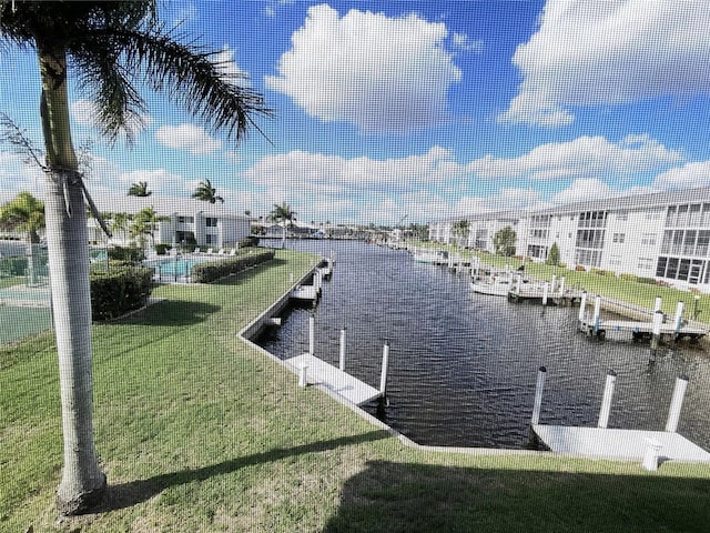 dock area featuring a lawn and a water view